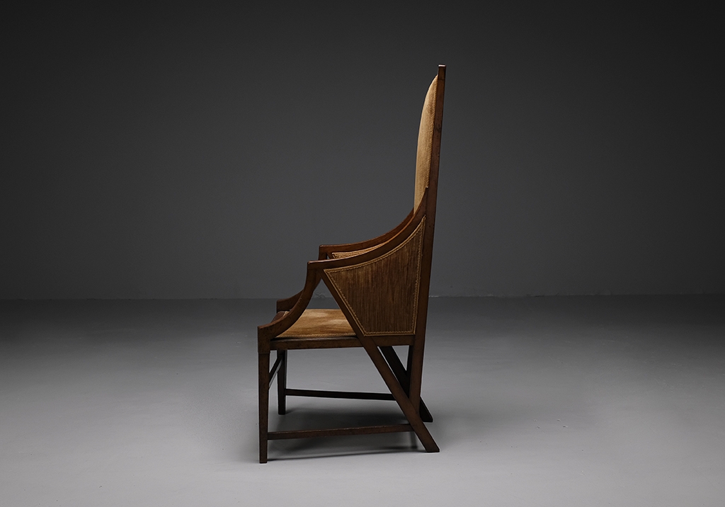Walnut armchair by Giacomo Cometti: Overall view of the armchair placed on its left side