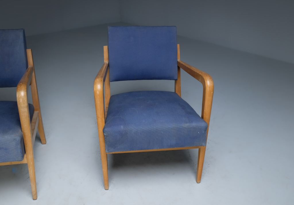 Armchairs by Henry Jacques Le Même: front view of a single chair with the other one peeking from the right