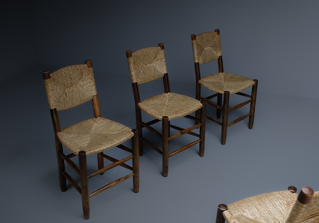 Set of 4 "Bauche" Chairs: diagonal row of three chairs facing frontally of the fourth wich is peeking from the lower right corner